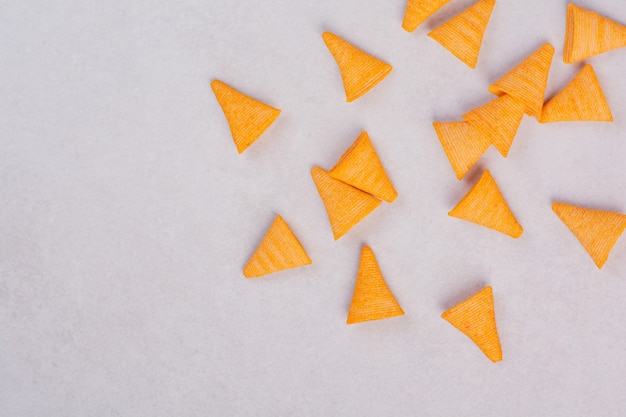 Tasty yellow crunchy chips on white background. High quality photo