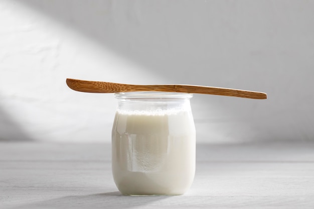 Tasty yogurt and wooden spoon arrangement