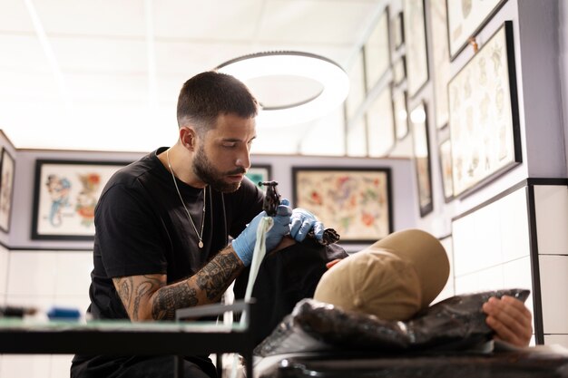 Tattoo artist doing his job medium shot