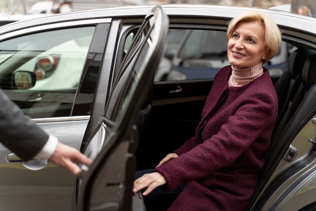 Taxi driver and female client interacting in a formal way