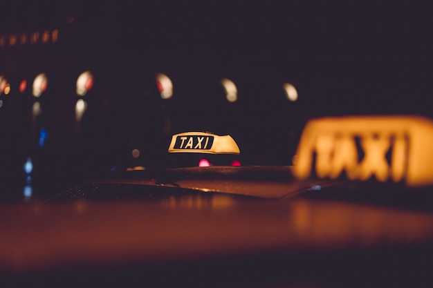 taxi sign on blurred city night background