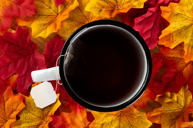 Tea over autumn leaves