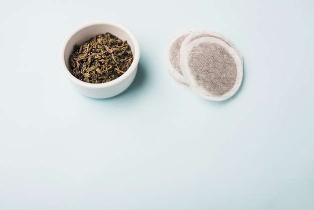 Tea bags from petals on blue background