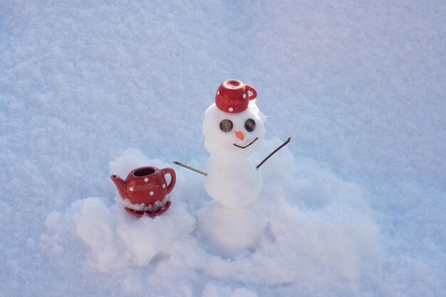 Tea or coffee break. little snowman with coffee tea cup. snowy weather.