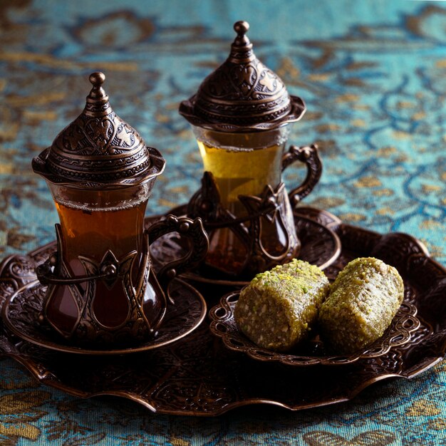 Tea cups arrangement with desert