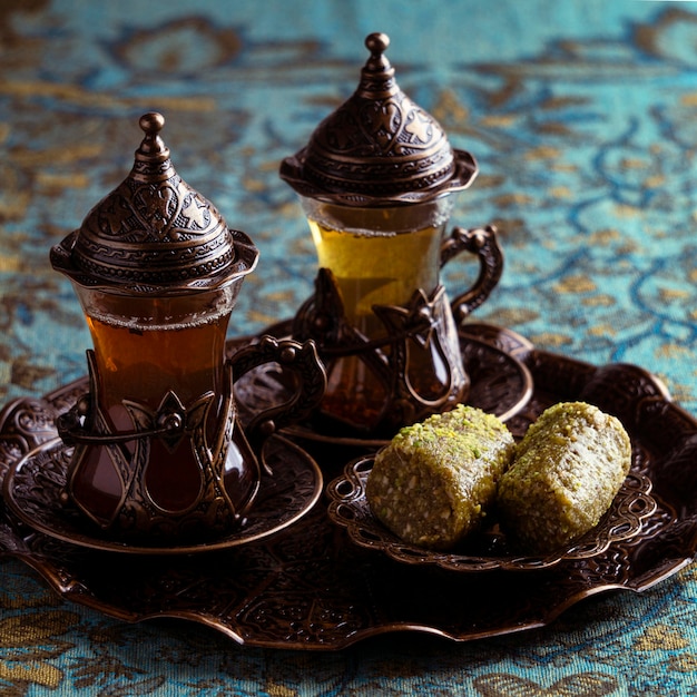 Tea cups arrangement with desert