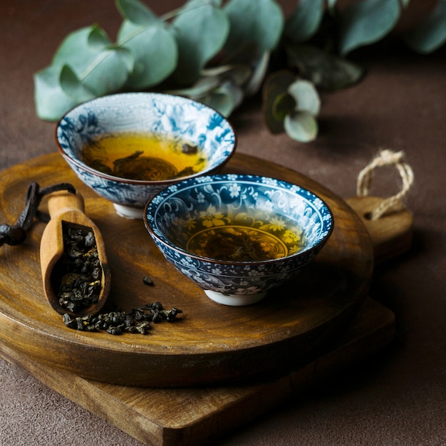 Tea cups arrangement on wooden board