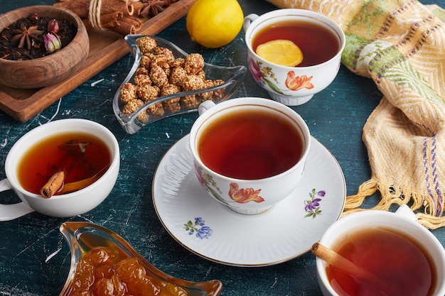 Tea cups with candy and confitures.