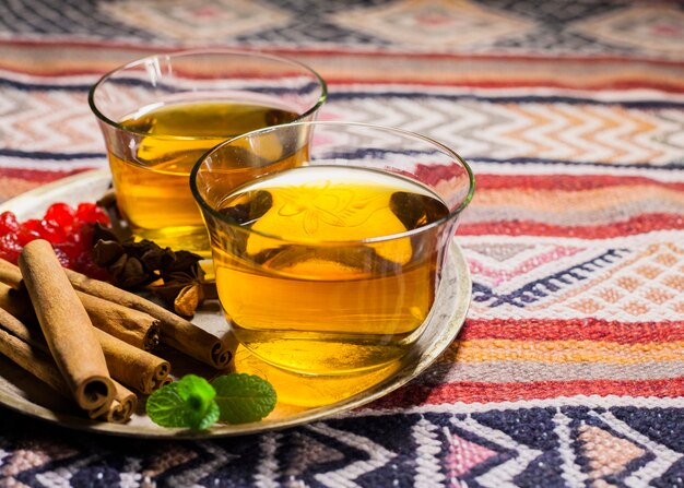 Tea cups with cinnamon on plate