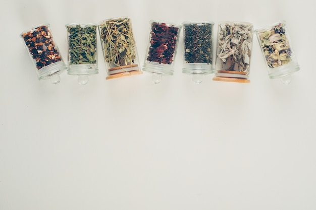 Free photo tea flavors in small jars. flat lay.