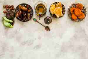 Free photo tea glass with different dried fruits and honeycomb