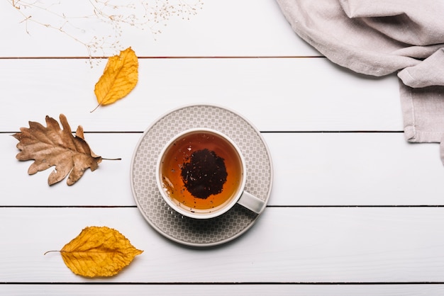 Tea and leaves near napkin