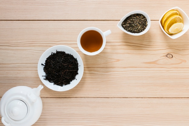 Tea leaves with kettle and lemon slices