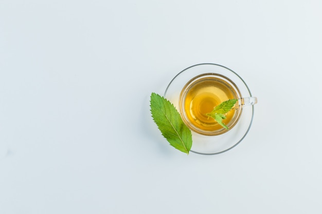 Tea in a mug with herbs flat lay on a white background