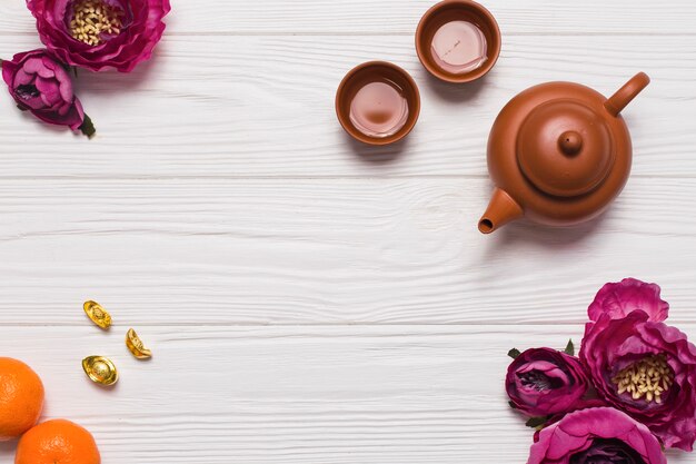 Tea set and flowers on wooden tabletop