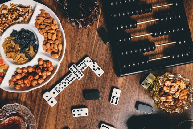 Tea set nuts dry fruits chocolate domino top view