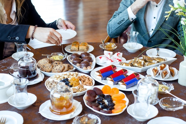 Tea set with candies, dried fruits and nuts, cookies, jams, lemon and baklava 2