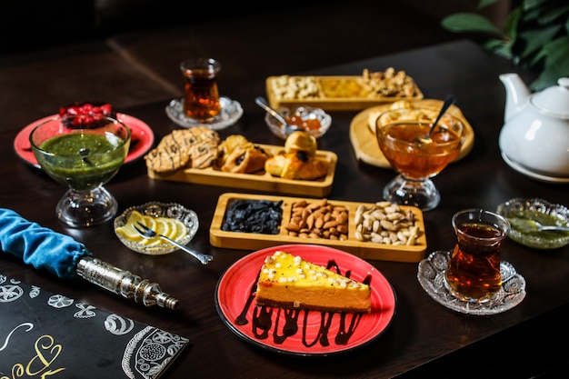 Tea set with sweets, lemon and jams