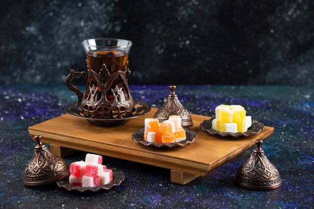 Tea set with Turkish delights on wooden board