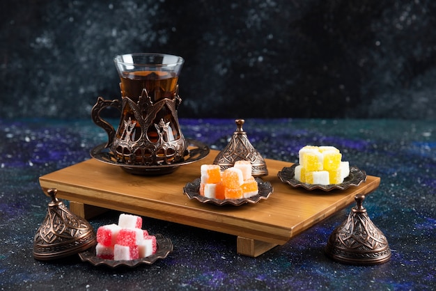 Tea set with Turkish delights on wooden board