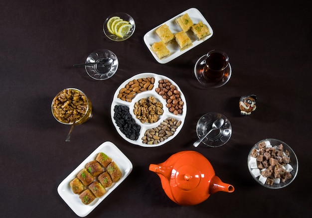 Tea table with tea glasses, nuts and top view.