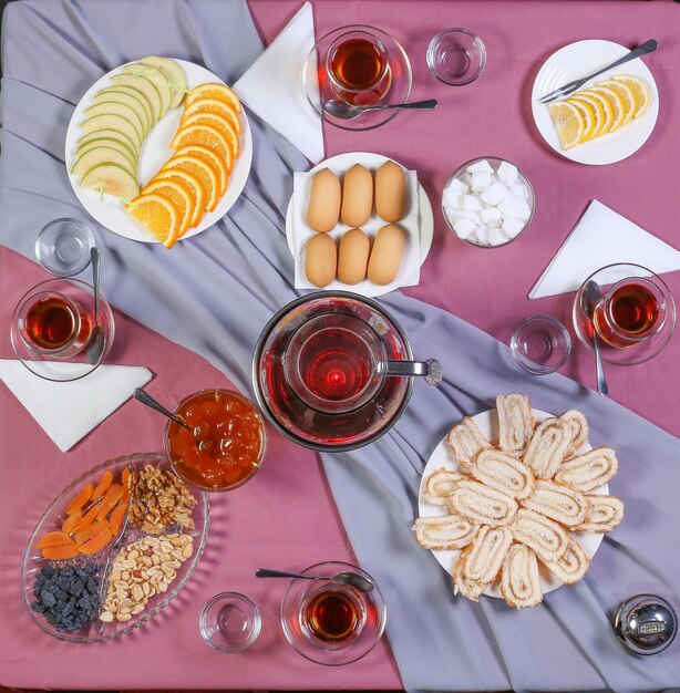 Tea table with tea and a variety of sweets and snacks.