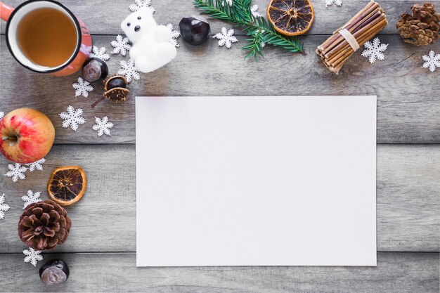 Tea and winter symbols near paper sheet