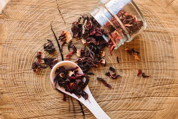 Tea with flower petals spilled from jar