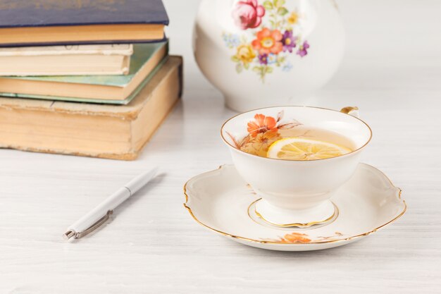 Tea with lemon and books on the table