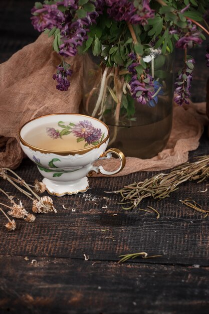 Tea with  lemon and bouquet of primroses on the table