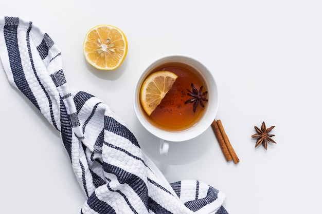 Tea with lemon near striped cloth