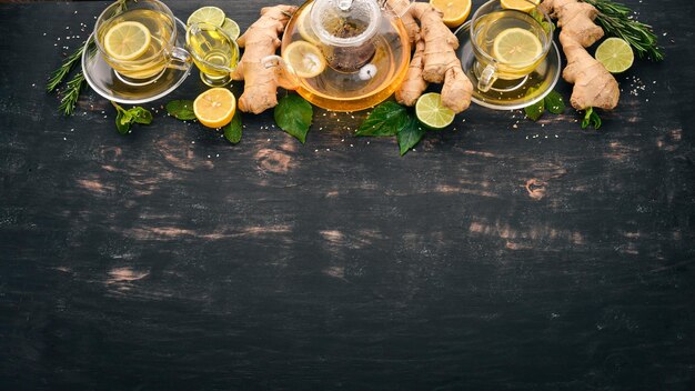 Tea with mint ginger and lemon hot drink on a wooden background top view copy space Premium Photo