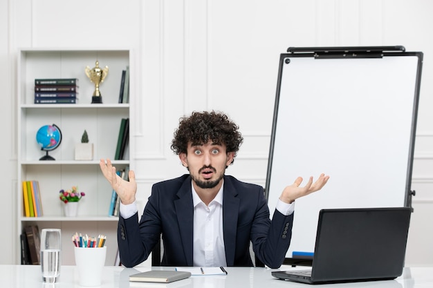 Free photo teacher brunette instructor with computer in suit and whiteboard in classroom confused