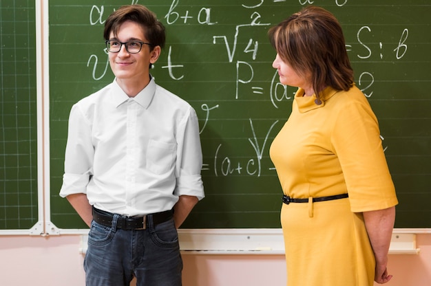 Free photo teacher explaining lesson to boy