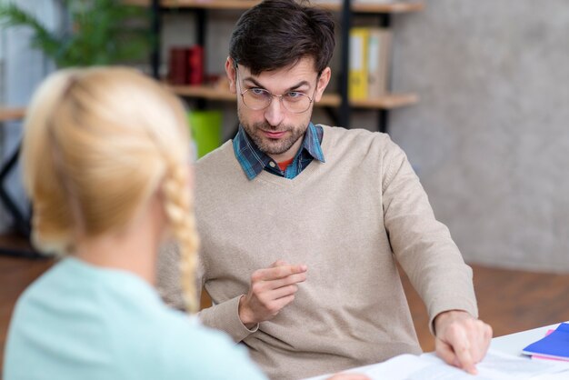 Teacher explaining to the young girl
