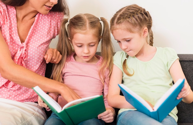 Free photo teacher helping her students read