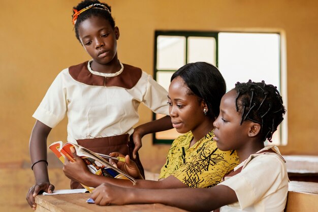 Teacher helping kids in class