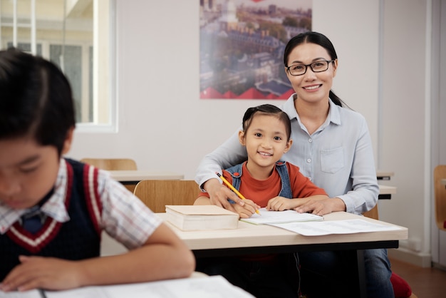 Free photo teacher helping student