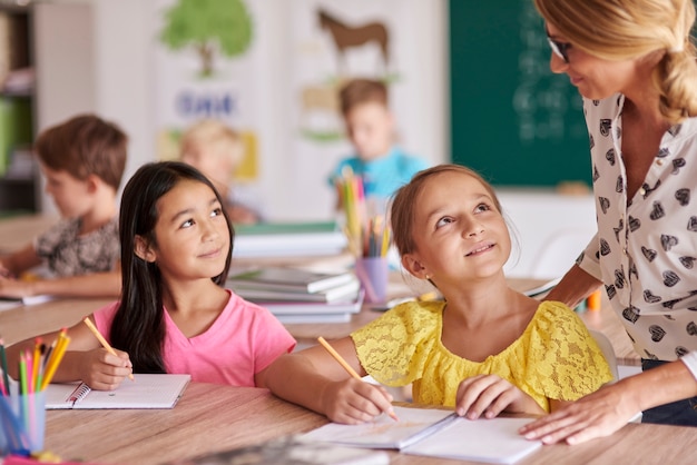 Free photo teacher and her two pupils