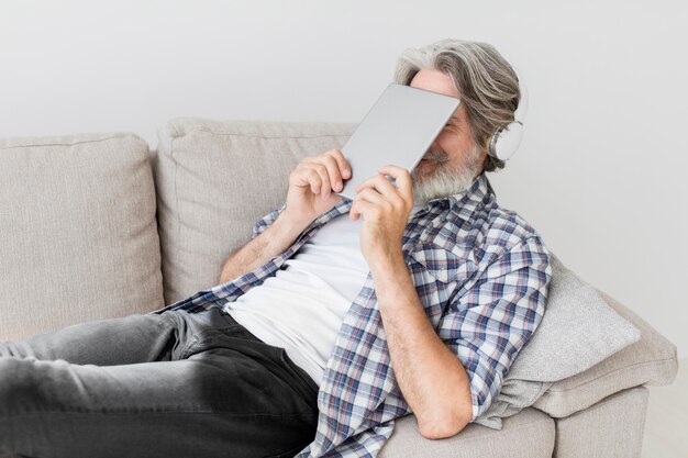 Teacher holding tablet close to face