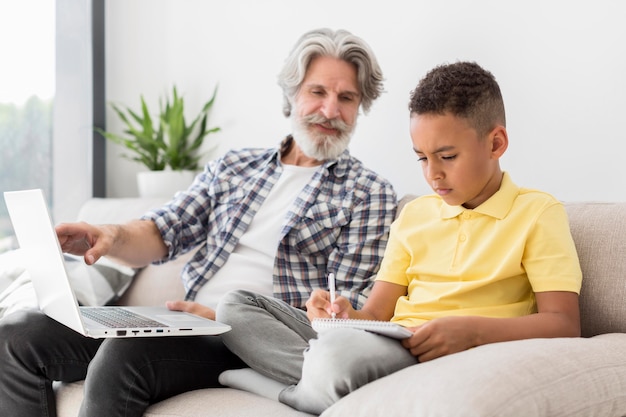 Free photo teacher looking at student writing on notebook