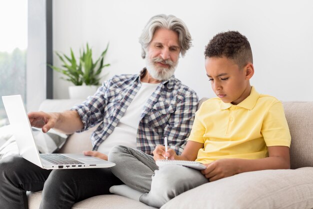 Teacher looking at student writing on notebook