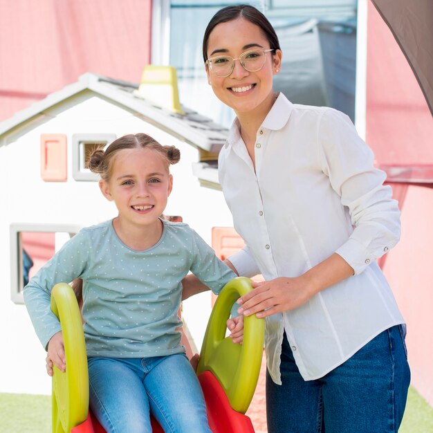 Teacher playing with her students outside