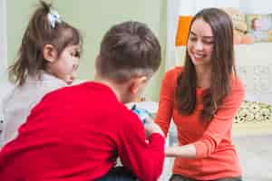 Free photo teacher playing with kids