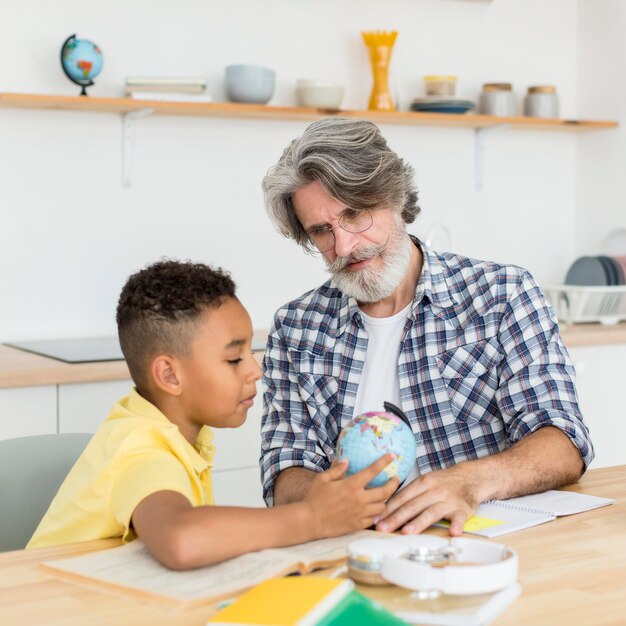 Teacher showing earth globe to student