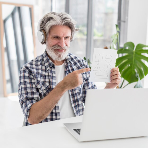 Teacher showing geometry shapes at laptop