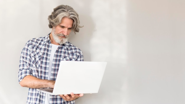 Free photo teacher standing and holding laptop