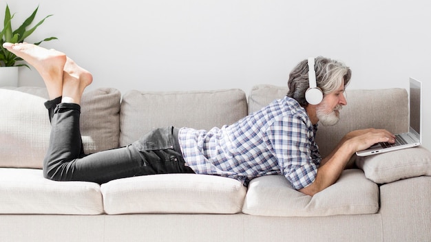 Teacher staying on couch using laptop