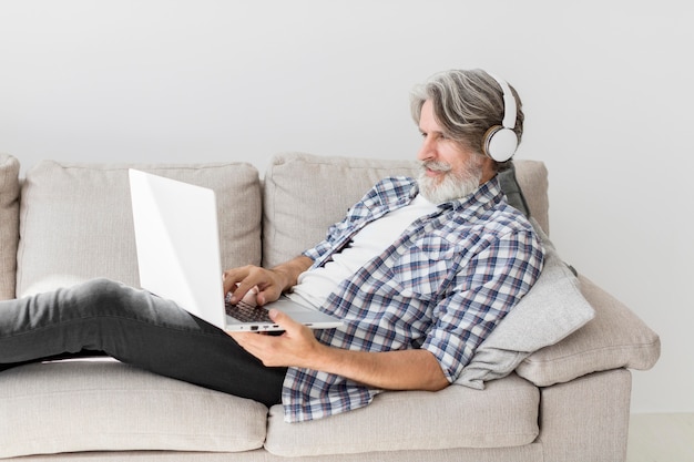 Teacher staying on couch with laptop