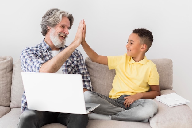 Teacher and student high fiving on couch